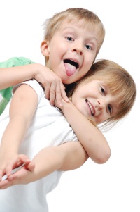 happy 5 year old girl and boy over white background