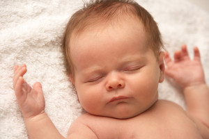 Close Up Of Baby Sleeping On Towel